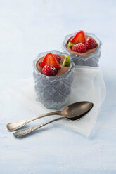 Glasses of Mousse au Chocolat garnished with raspberries, strawberries and hardy kiwi - MYF001409