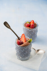 Glasses of Mousse au Chocolat garnished with raspberries, strawberries and hardy kiwi - MYF001412
