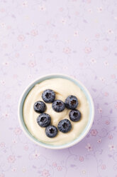 Bowl of custard garnished with heart of blueberries - MYF001416