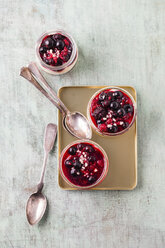 Glasses of vanilla cream with berry sauce and chopped almonds - MYF001419