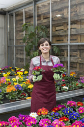 Young female gardener working in greenhouse - ALBF000039