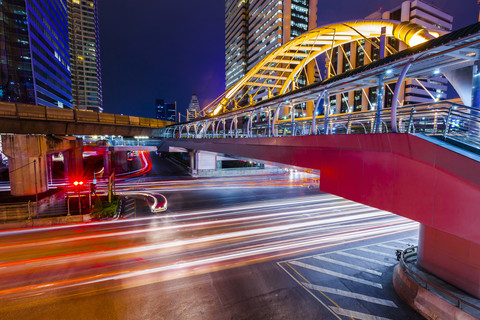 Thailand, footbridge and traffic in Bangkok at night stock photo