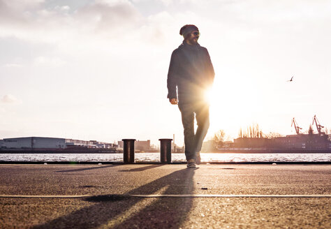 Germany, Hamburg, Man walking at the landing stages - BMA000195