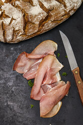 Slices of raw ham, parlsey, knife and bred - KSWF001746