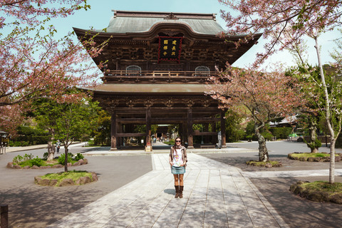Japan, Kamakura, woman standing in front of Kencho-ji temple stock photo
