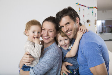 Portrait of Parents with two sons, happily smiling - FMKF002544