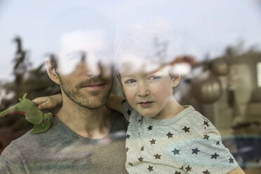 Father and son looking out of window - FMKF002565