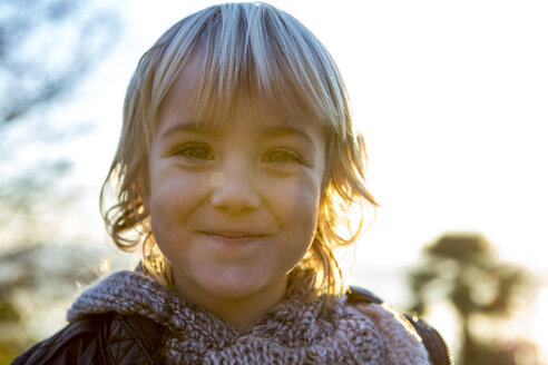 Portrait of happy blond boy at backlight - ZOCF000018