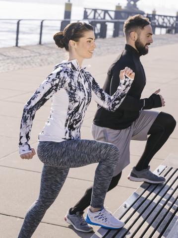 Germany, Cologne, Young couple worming up for workout stock photo