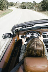 Woman driving a convertible car - ABZF000295