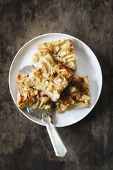 Pieces of whole meal apple pie with sliced almonds on a plate - EVGF002864