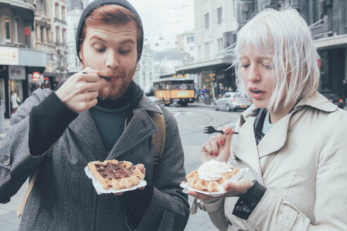 Belgium, Antwerp, young couple eating Belgian waffles on the street - RTBF000026