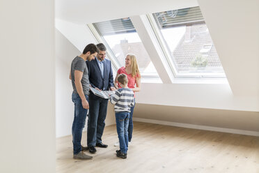 Estate agent showing family sample card in their new penthouse - SHKF000530