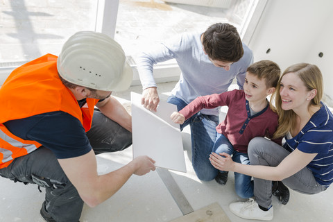 Construction worker showing family tile sample stock photo