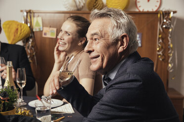 Älterer Mann trinkt Champagner auf einer Silvesterparty - MFF002937