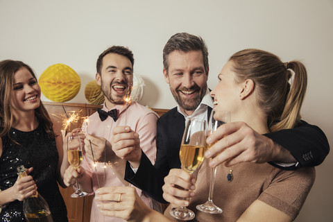 Friends celebrating New Year's Eve together, drinking champagne stock photo