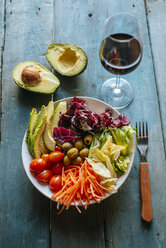 Mixed salad , sliced avocado and glass of red wine - KIJF000278