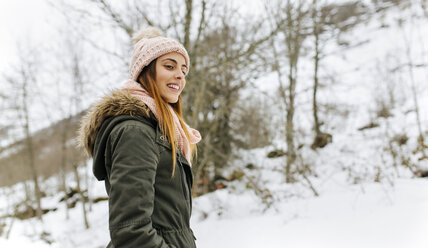 Spain, Asturias, happy young woman in the snowy mountains - MGOF001633