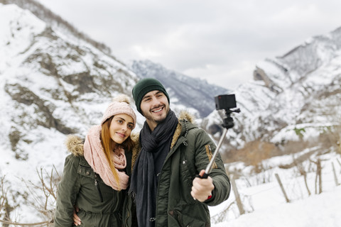 Spain, Asturias, couple taking selfie in the snowy mountains stock photo