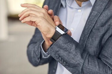 Close-up of businessman with smartwatch - MAEF011414