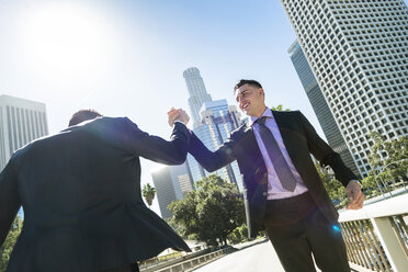 USA, Los Angeles, two businessmen high fiving - LEF000021