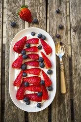 Plate of chia pudding with blueberries and sliced strawberries - SARF002663