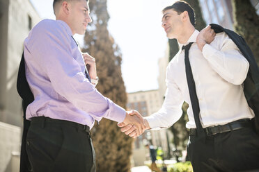 Two businessmen shaking hands outdoors - LEF000026