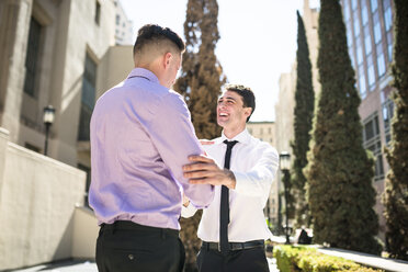 Two businessmen shaking hands outdoors - LEF000027