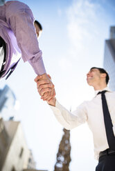 Two businessmen shaking hands outdoors - LEF000028