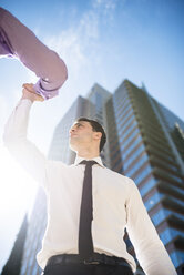 Two businessmen high fiving outdoors - LEF000030