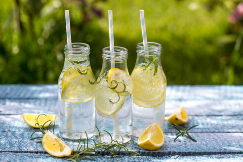 Slice of lemon and rosmary in water bottles, drinking straws - SARF002670