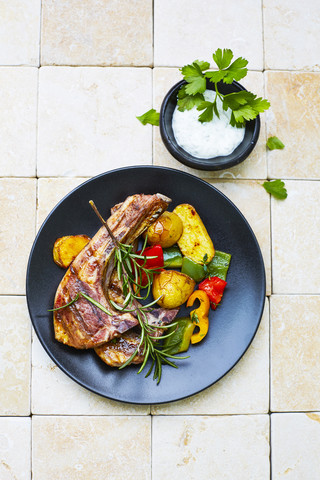 Lamb chops, potatoes and grilled vegetables on plate stock photo