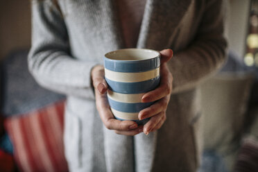 Young woman at home drinkin cup of coffee - HAPF000305