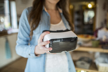 Young woman at home using Virtual Reality goggles - HAPF000327