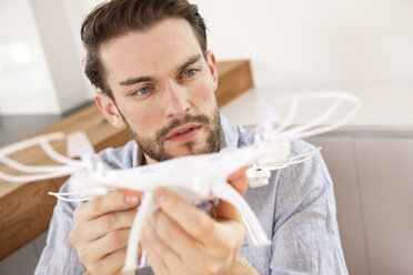 Portrait of young man with drone - MFRF000534