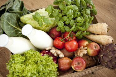 Wooden box of fresh vegetables and two bottles of milk - MFRF000584