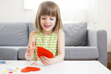 Portrait of embroidering little girl at home - LVF004702