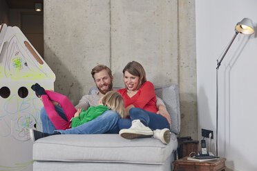 Happy family of three relaxing at home - RHF001382