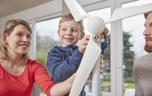 Family assembling toy wind turbine together - RHF001407