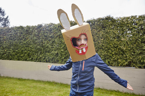 Boy wearing bunny mask in garden - RHF001422