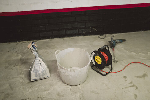 Cement bag, bucket and cable roll at construction site - RAEF001004