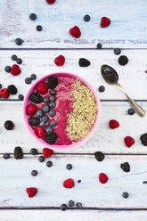 Bowl with fruit smoothie garnished with berries and hemp seeds - LVF004713