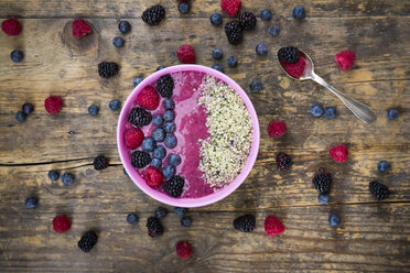 Bowl with fruit smoothie garnished with berries and hemp seeds - LVF004714