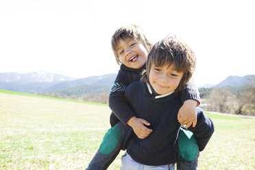 Portrait of little boy carrying his brother piggyback - VABF000420