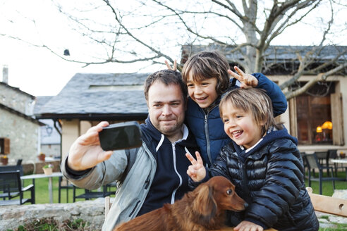 Vater macht ein Selfie mit seinen Söhnen und dem Hund mit Smartphone - VABF000425