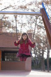 Portrait of smiling little girl on a swing - XCF000072