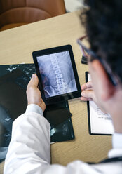 Doctor looking at x-ray image on digital tablet - DAPF000059