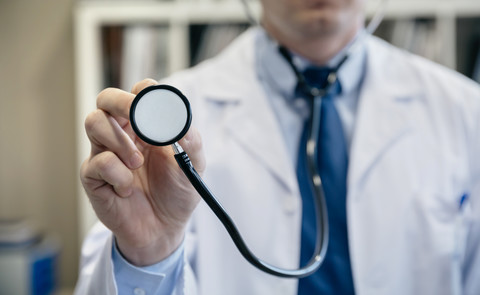 Close-up of doctor holding stethoscope stock photo