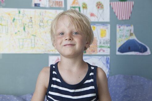 Portrait of confident little blond boy at children's room - RBF004251