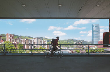 Spain, Bilbao, man riding racing cycle on a bridge - RTBF000099